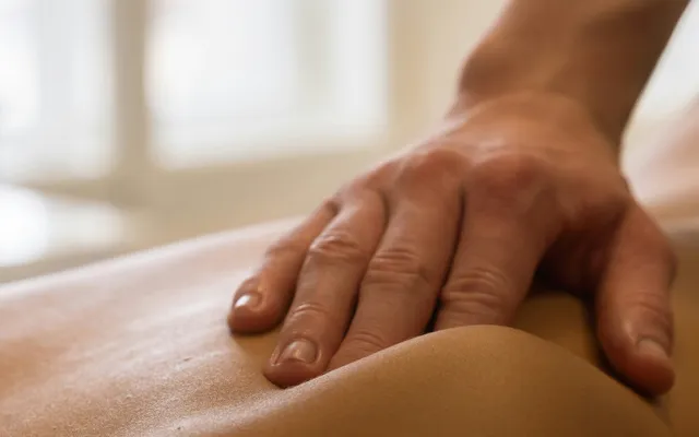Close-up of hands applying firm pressure during a deep tissue technique